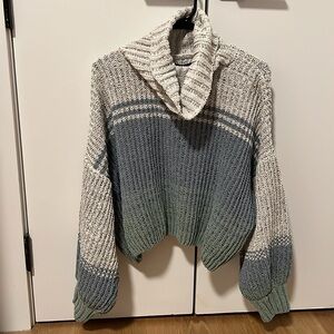 Multi colored sweater with a cowl neck. Knit material. Size small. Oversized fit